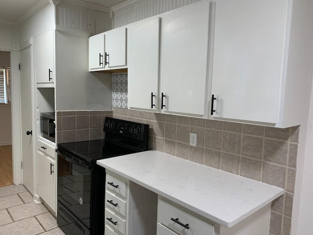 kitchen featuring tasteful backsplash, electric range, white cabinets, and light tile patterned flooring