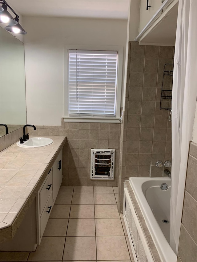 bathroom featuring heating unit, tile walls, tile patterned flooring, vanity, and shower / bath combo