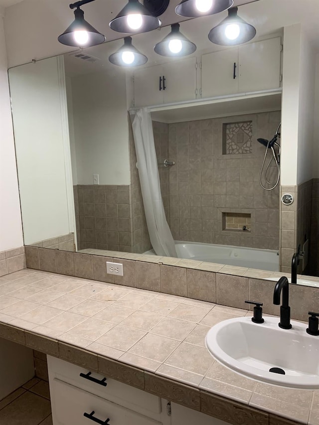 bathroom featuring shower / tub combo and vanity