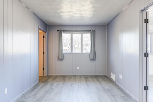 unfurnished room featuring light hardwood / wood-style floors