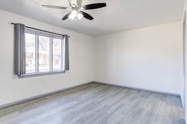 spare room featuring ceiling fan and light wood-type flooring