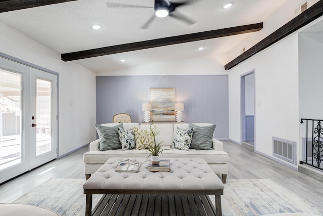 living room with french doors, lofted ceiling with beams, a textured ceiling, and light wood-type flooring