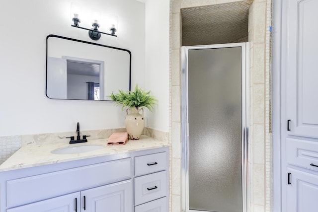 bathroom featuring vanity and an enclosed shower