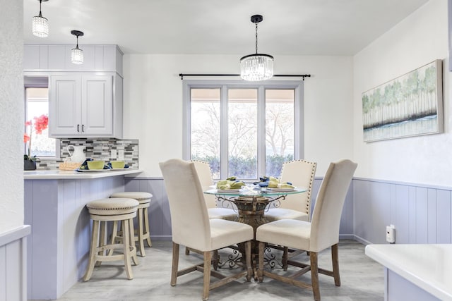 dining area with an inviting chandelier, plenty of natural light, and light hardwood / wood-style floors