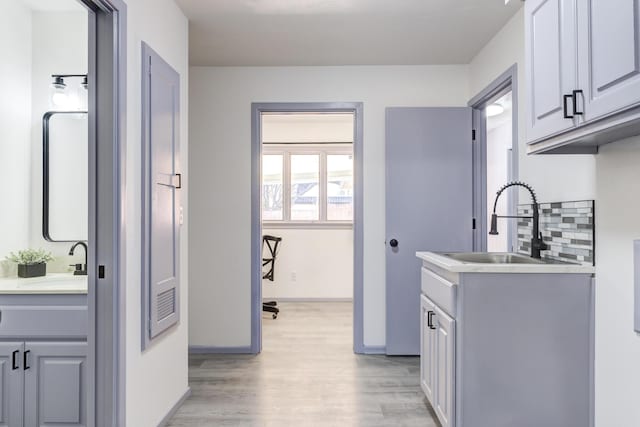 washroom featuring sink and light hardwood / wood-style floors