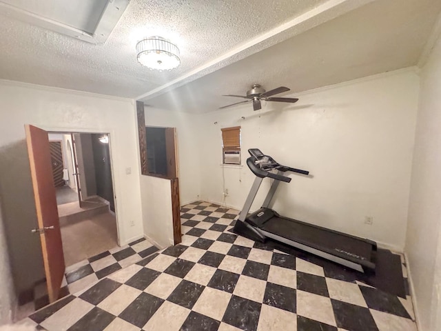 workout area with ceiling fan and a textured ceiling