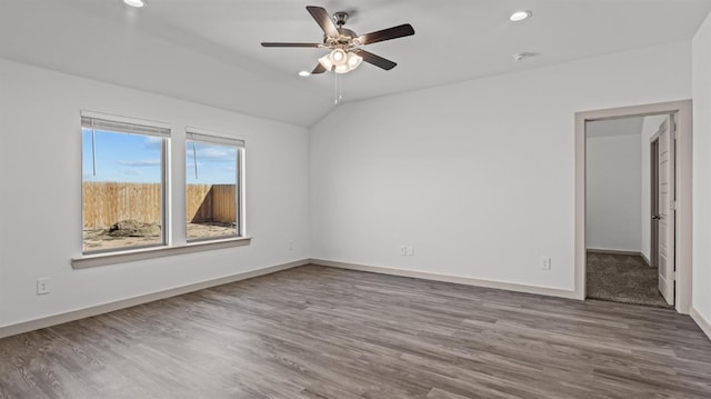 unfurnished room with ceiling fan, lofted ceiling, and wood-type flooring