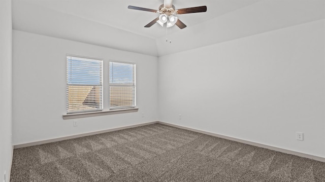 spare room with ceiling fan, vaulted ceiling, and carpet