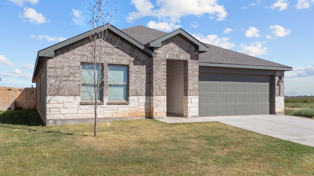 view of front of house with a garage and a front lawn