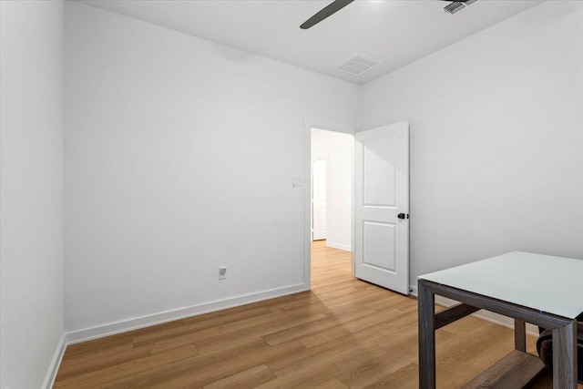 spare room with ceiling fan and light wood-type flooring