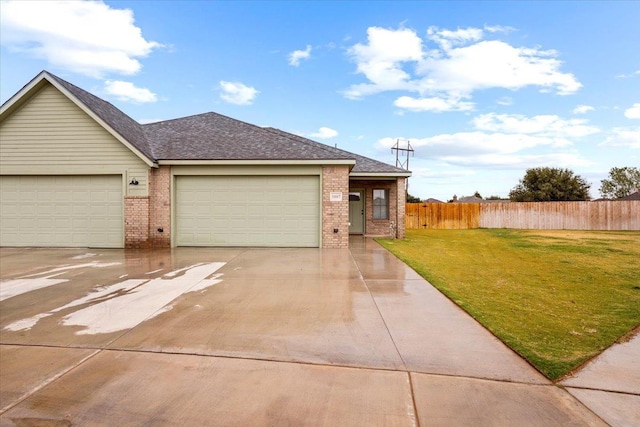 single story home featuring a garage and a front yard