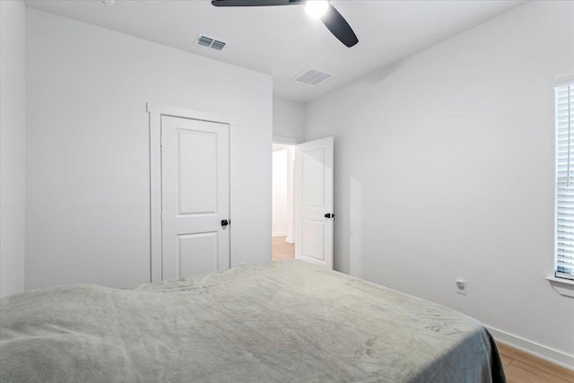 bedroom with ceiling fan and light hardwood / wood-style floors