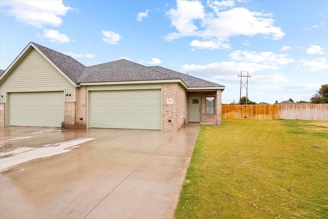 single story home featuring a garage and a front yard