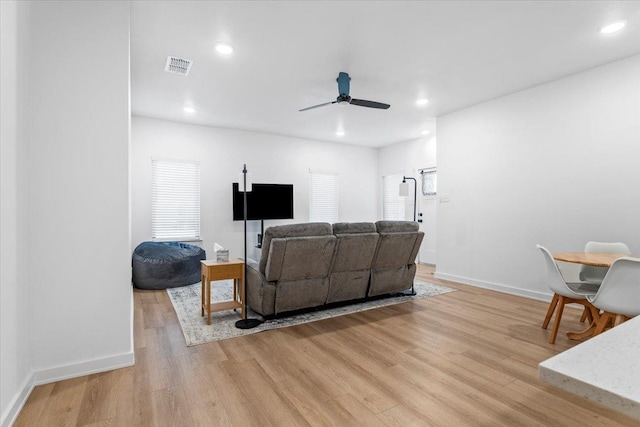 living room featuring ceiling fan and light wood-type flooring