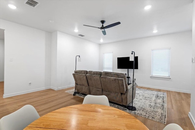 living room with ceiling fan and light hardwood / wood-style floors