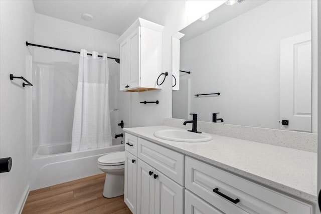 full bathroom with vanity, toilet, hardwood / wood-style floors, and shower / bath combo