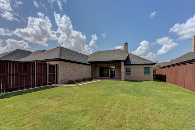 4603 140th St, Lubbock, TX 79424 - rear view of property featuring brick siding, a chimney, and a shingled roof