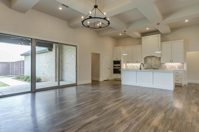 4603 140th St, Lubbock, TX 79424 - unfurnished living room featuring dark wood finished floors, coffered ceiling, a chandelier, beam ceiling, and recessed lighting