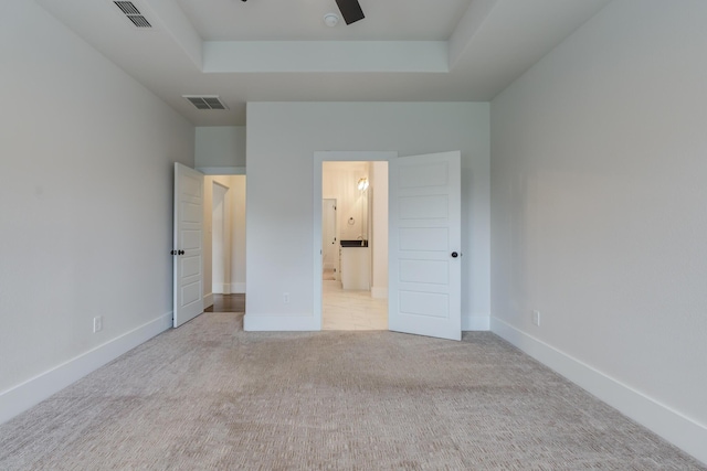 4603 140th St, Lubbock, TX 79424 - unfurnished bedroom with carpet, connected bathroom, and a tray ceiling