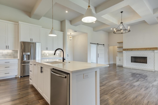 4603 140th St, Lubbock, TX 79424 - kitchen featuring stainless steel appliances, a barn door, open floor plan, backsplash, and coffered ceiling