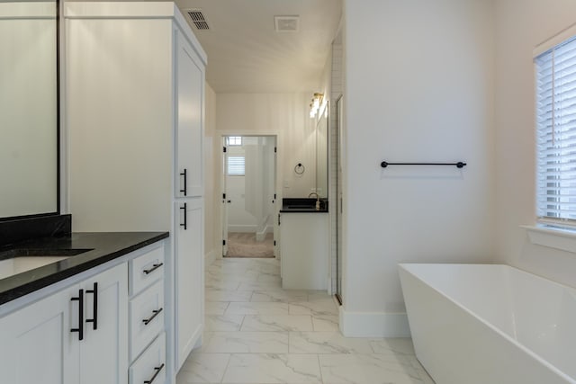 4603 140th St, Lubbock, TX 79424 - bathroom with marble finish floors, a soaking tub, and vanity