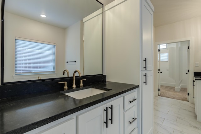 4603 140th St, Lubbock, TX 79424 - bathroom with marble finish floors, vanity, and recessed lighting
