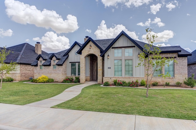 4603 140th St, Lubbock, TX 79424 - view of front facade with board and batten siding, a front lawn, a chimney, and stone siding