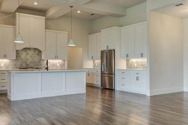 4603 140th St, Lubbock, TX 79424 - kitchen with stainless steel fridge with ice dispenser, decorative backsplash, light countertops, white cabinets, and dark wood-style floors