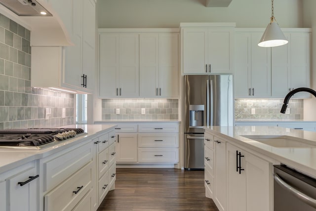 4603 140th St, Lubbock, TX 79424 - kitchen featuring appliances with stainless steel finishes, wall chimney exhaust hood, light countertops, and tasteful backsplash