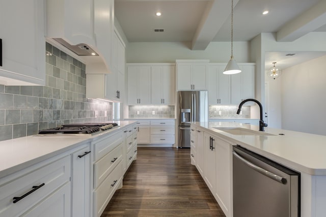 4603 140th St, Lubbock, TX 79424 - kitchen with appliances with stainless steel finishes, backsplash, white cabinetry, light countertops, and a kitchen island with sink