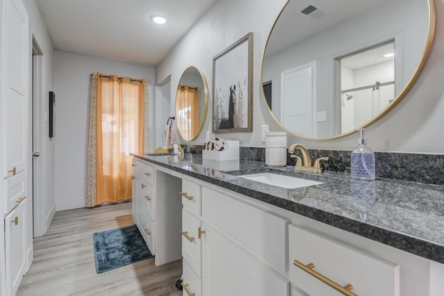 bathroom with hardwood / wood-style flooring and vanity