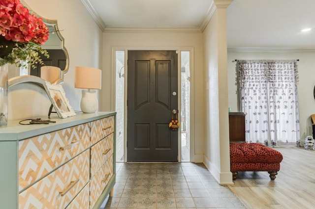 tiled entrance foyer featuring ornamental molding