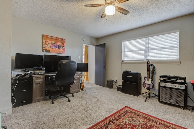 office area with ceiling fan, light carpet, and a textured ceiling