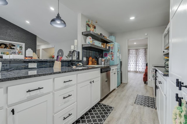 kitchen featuring decorative light fixtures, stainless steel dishwasher, light hardwood / wood-style floors, and white cabinets