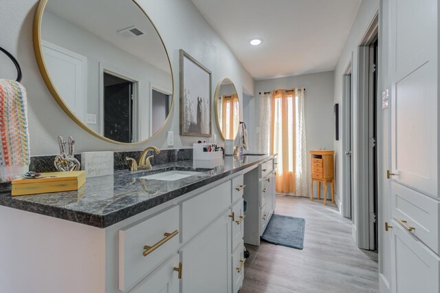 bathroom with wood-type flooring and vanity