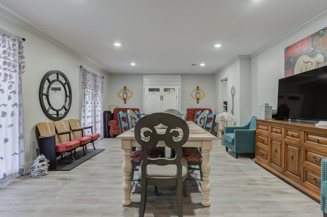 dining space featuring crown molding and light wood-type flooring