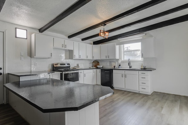 kitchen featuring dark countertops, dishwasher, white cabinetry, and electric stove