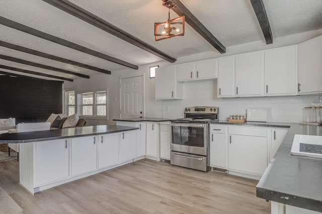 kitchen featuring dark countertops, white cabinets, stainless steel range with electric cooktop, and decorative light fixtures