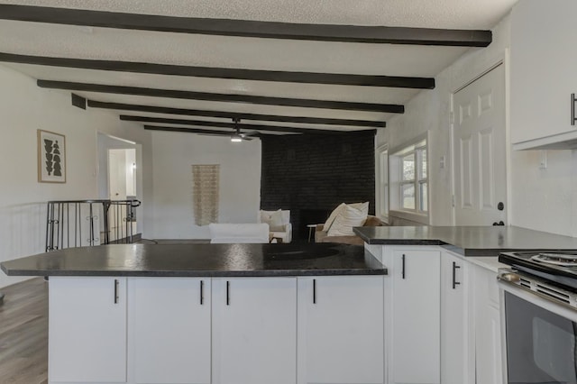 kitchen featuring dark countertops, white cabinetry, and a peninsula