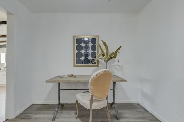 office space featuring baseboards and wood finished floors