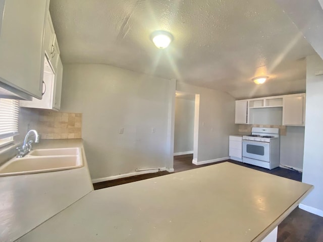 kitchen with sink, white cabinetry, a textured ceiling, decorative backsplash, and white gas stove