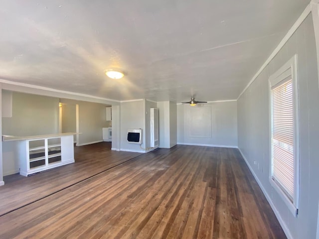 unfurnished living room with heating unit, dark wood-type flooring, ornamental molding, and ceiling fan