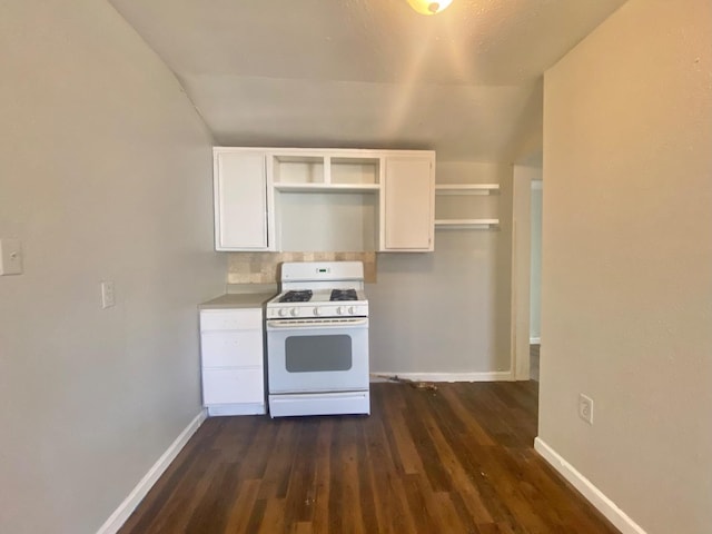 kitchen featuring white cabinetry, vaulted ceiling, dark wood-type flooring, and white range with gas stovetop