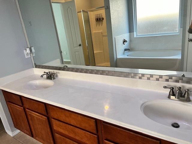 bathroom featuring vanity, tile patterned flooring, tasteful backsplash, and separate shower and tub