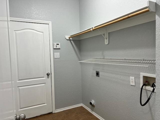 laundry room with washer hookup, dark tile patterned floors, and electric dryer hookup