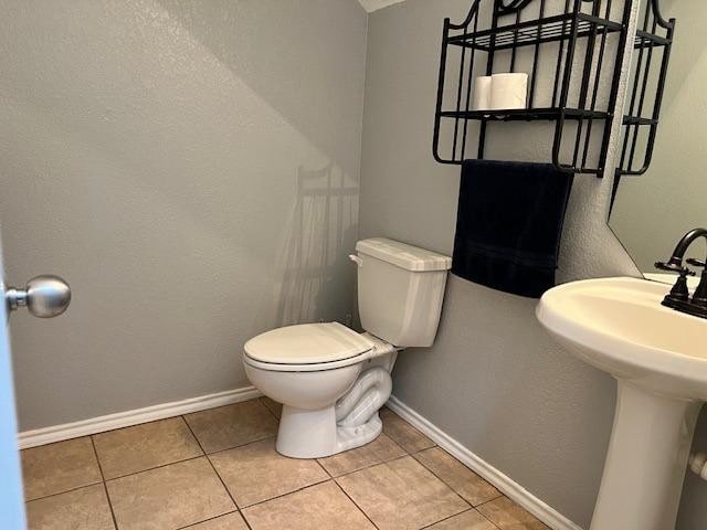 bathroom featuring tile patterned flooring, sink, and toilet