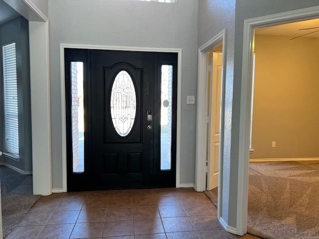 foyer featuring tile patterned floors and a healthy amount of sunlight