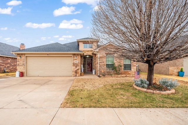 view of front of home with a garage and a front lawn