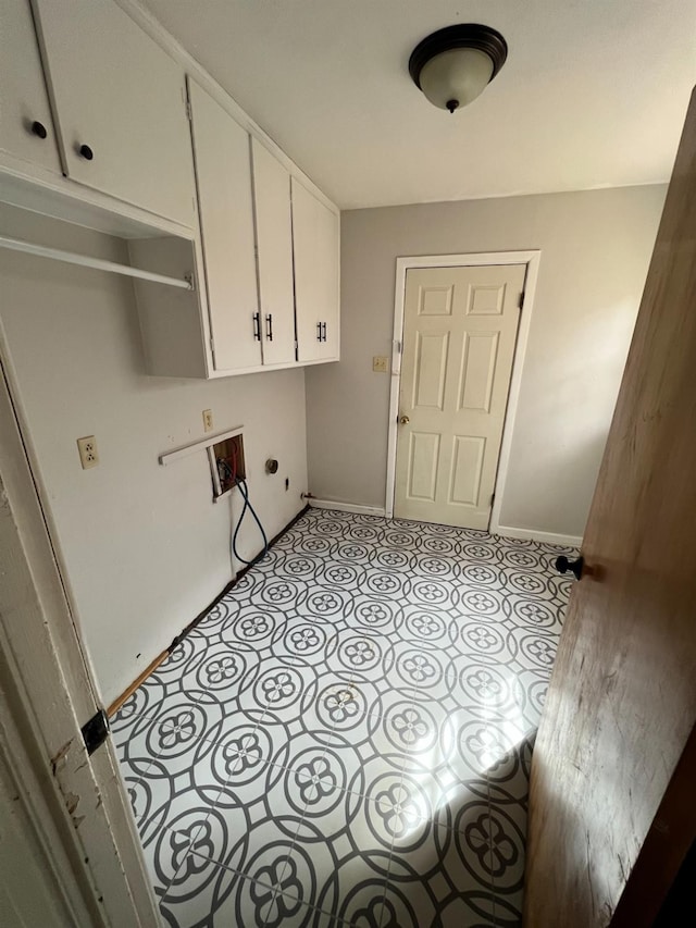 clothes washing area featuring cabinets, washer hookup, and light tile patterned floors