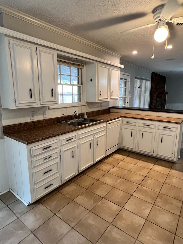 kitchen with sink, a textured ceiling, ornamental molding, dishwasher, and white cabinets